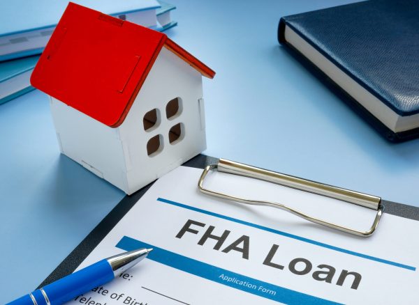 FHA loan application and model of home. fha-loan-application